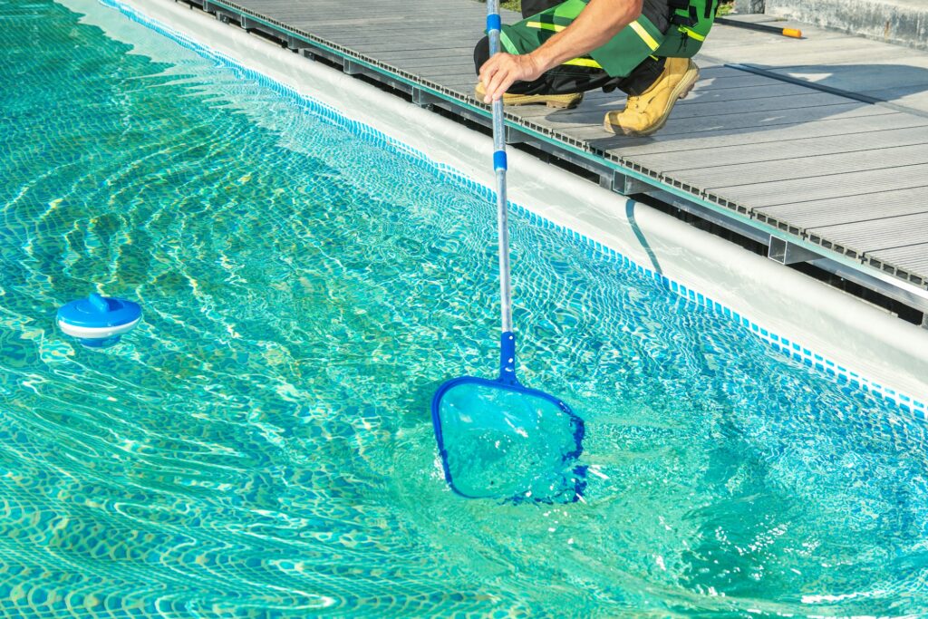 Cleaning Swimming Pool with Skimmer Net - Cómo Invernar tu Piscina Correctamente - Jujuju, Tienda de Artículos para Piscinas y Soluciones Integrales en Alicante