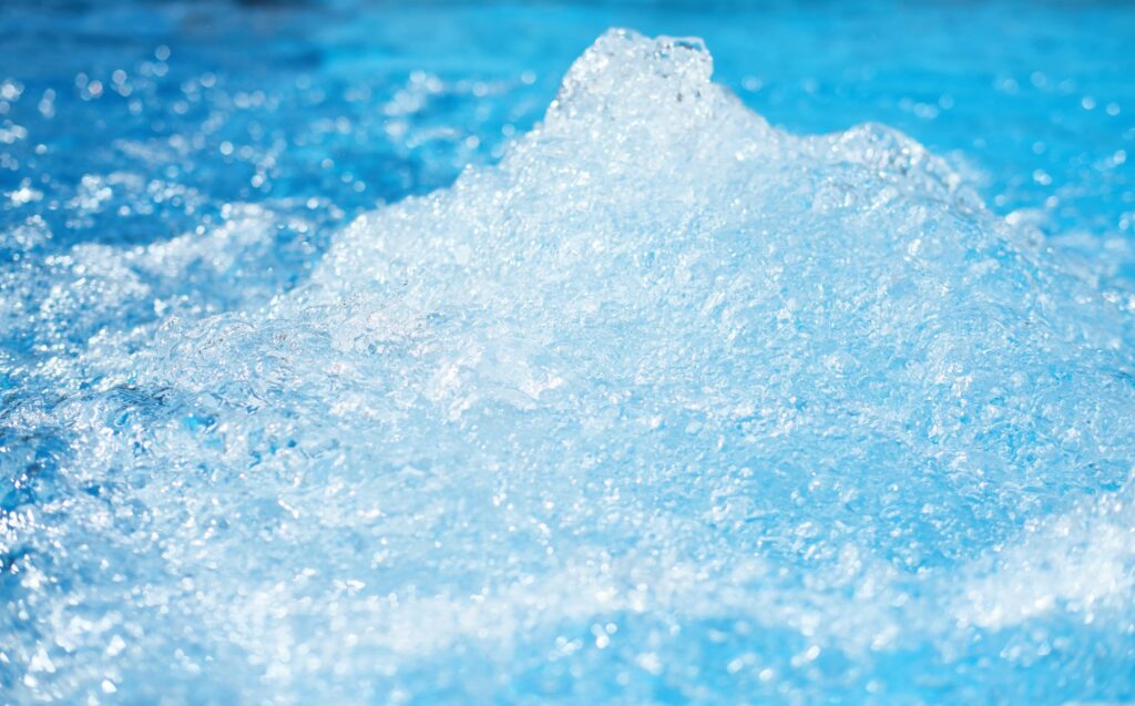 Blue clear fresh Water in jacuzzi. Spa massage background.